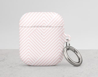 May include: A pink and white geometric patterned case for AirPods with a silver metal keychain.