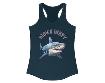 May include: Navy blue racerback tank top featuring a detailed illustration of a shark with open jaws. The text "DIGG'N DIRTY" is arched above the shark. The shark is white and blue, with a detailed rendering of teeth and gills.