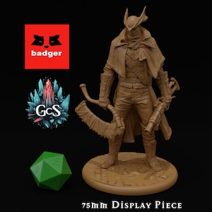 May include: A brown 3D printed miniature of a character wearing a long coat, a mask, and holding a weapon. The miniature is standing on a 2-inch round base. 75mm Display Piece 50mm Base