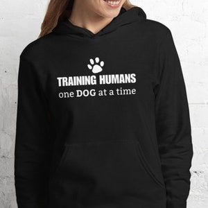 Funny dog trainer hoodie sweatshirt. Dog trainer gift. Hoodie that says Training Humans one DOG at a time.