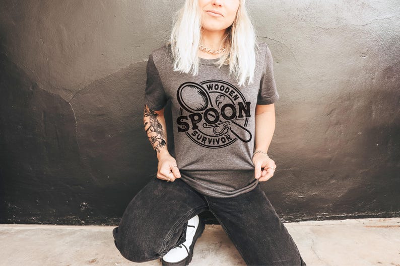 May include: A gray t-shirt with a black graphic of a wooden spoon and the text "Wooden Spoon Survivor".