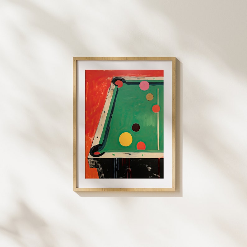 May include: A framed painting depicting a green pool table with colourful balls on the felt. The table is set against a red background.