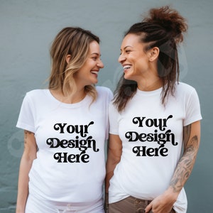 May include: Two people wearing white t-shirts with the text "Your Design Here" in a retro font. They are smiling and looking at each other.