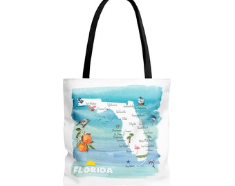 May include: A white tote bag featuring a watercolour map of Florida. The map highlights key cities and landmarks, such as Key West, Miami, Orlando, and Jacksonville. The bag has black handles and the word "FLORIDA" printed in black at the bottom.