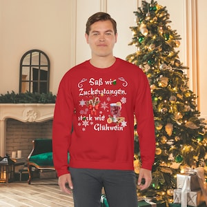 Sweet as candy canes, strong as mulled wine - the Christmas sweater goes perfectly with mulled wine by the fireplace