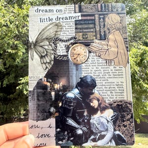 May include: A collage featuring a butterfly, a pocket watch, and a couple in medieval attire. The text "dream on little dreamer" is visible. The collage is held up against a backdrop of green foliage.