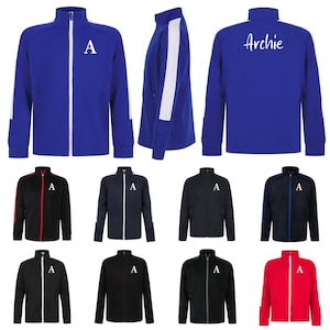 May include: A set of ten blue, red, black and navy blue track jackets with white piping. Some jackets have a white letter 'A' on the front, while others have the name 'Archie' in white lettering.