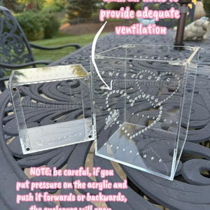 May include: Two clear acrylic enclosures with 2mm air holes for ventilation. One enclosure is open, the other is closed. The text on the image reads: "NOTE: be careful, if you put pressure on the acrylic and push it forwards or backwards, the enclosure will open."