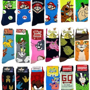 May include: A collection of colorful crew socks featuring various cartoon characters and themes. Designs include Super Mario, Scooby-Doo, Tom & Jerry, Shrek, Star Trek, Looney Tunes, SpongeBob SquarePants, and Monopoly. Each pair has a unique graphic.