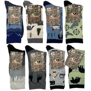 May include: Eight pairs of men's socks with different camouflage patterns. The socks are all Mossy Oak brand and feature various hunting-themed designs, including deer, ducks, and trees. The socks are all size 6-12.