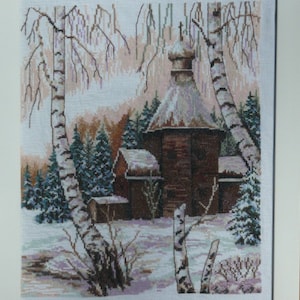 May include: A cross-stitch embroidery depicting a snowy winter scene with a small wooden church, birch trees, and a snow-covered landscape.