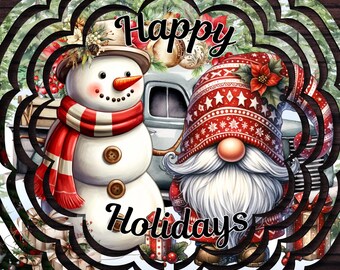 May include: A circular metal wind spinner featuring a festive graphic of a snowman with a red scarf and a gnome in a red patterned hat. The text "Happy Holidays" is printed in black script. The design includes a vintage truck and pine trees.