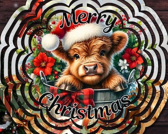 May include: A circular metal wind spinner ornament featuring a fluffy brown Highland calf wearing a red and white Santa hat, sitting in a bucket with red poinsettias and a plaid bow, with the text Merry Christmas printed in black script.