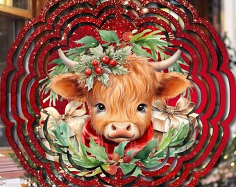 May include: A circular hanging wind spinner featuring a central illustration of a fluffy Highland calf wearing a red scarf, surrounded by green holly leaves, red berries, and gift boxes, all framed by a scalloped red border with glitter accents.
