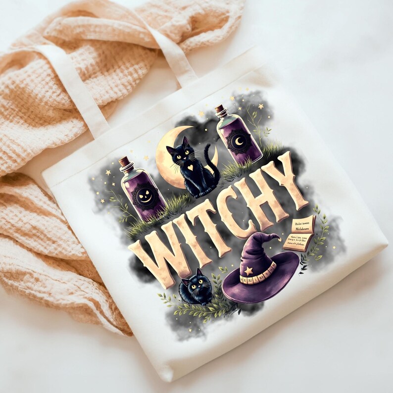 May include: A white canvas tote bag featuring a graphic print with the word WITCHY in large beige letters. The design includes two black cats, a crescent moon, two purple potion bottles, a witch hat, and an open book amidst dark smoke.