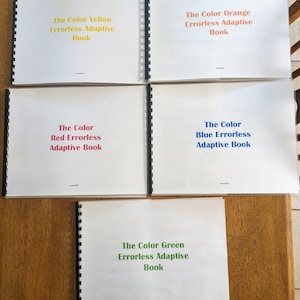 Puede incluir: Cinco libros encuadernados en espiral con cubiertas blancas y texto de colores. Los títulos son "The Color Yellow Errorless Adaptive Book", "The Color Orange Errorless Adaptive Book", "The Color Red Errorless Adaptive Book", "The Color Blue Errorless Adaptive Book" y "The Color Green Errorless Adaptive Book".
