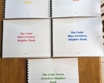 May include: Five spiral bound books with white covers and colourful text. The titles are "The Color Yellow Errorless Adaptive Book", "The Color Orange Errorless Adaptive Book", "The Color Red Errorless Adaptive Book", "The Color Blue Errorless Adaptive Book", and "The Color Green Errorless Adaptive Book".