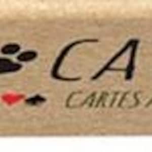 May include: A deck of playing cards with a brown background and the text "Yoga Cats" in black. The cards feature illustrations of cats in yoga poses. The text "Playing Cards" and "Cartes a Jouer" are also visible.
