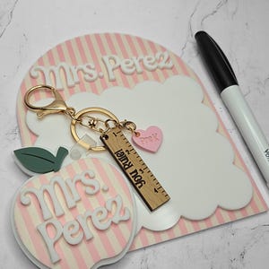 Reusable dry erase teacher desk board with scalloped whiteboard design and personalized teacher name. Classroom notepad used for reminders, daily notes, and lesson planning. Unique teacher appreciation gift idea, new teacher classroom decor piece, and back to school teacher desk accessory. Pair it with a matching apple keychain.