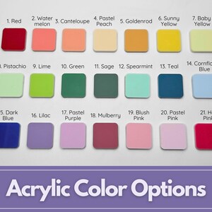 May include: A display of 21 square acrylic color swatches, each labeled with a color name. Colors range from red and yellow to blue and pink, with names like "Watermelon," "Lilac," and "Hot Pink." The text "Acrylic Color Options" is at the bottom.