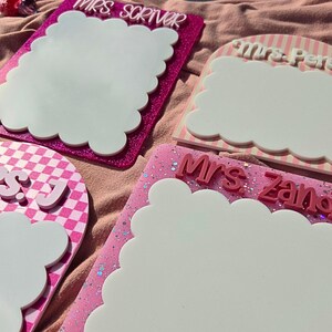 Personalized teacher name dry erase board with scalloped design used as a classroom desk notepad. Reusable whiteboard writing surface perfect for reminders, lesson plans, and daily tasks. Popular gift idea for teacher appreciation week, new teacher classroom setup, and back to school teacher desk decor.