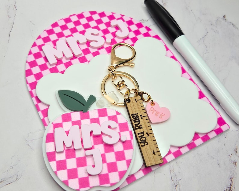 Teacher dry erase note board with apple keychain and personalized name in layered acrylic. Small reusable classroom whiteboard used as a teacher desk notepad for reminders and daily classroom tasks. Thoughtful teacher appreciation gift, back to school classroom gift, and personalized teacher desk decor.