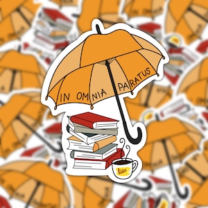 May include: A yellow umbrella with the text "In Omnia Paratus" printed on it, a stack of books, and a coffee cup with the text "Luke's" printed on it.