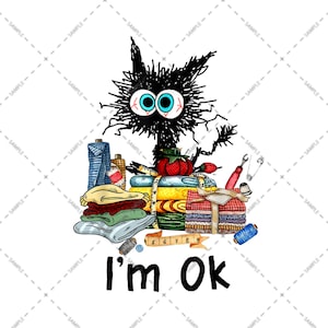 May include: A black cat with blue eyes is surrounded by a pile of colorful fabric scraps, sewing notions, and a measuring tape. The text "I'm Ok" is written below the cat.