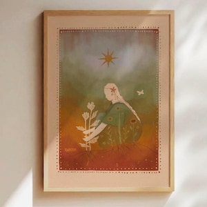 May include: Framed art print featuring a seated figure tending to flowers. The artwork has a warm color palette with a sun and butterfly. The print is in a light wood frame, suitable for home decor.