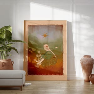 May include: A framed art print featuring a woman with butterfly wings, holding flowers, under a sun. The artwork has a warm color palette with a light brown frame. A potted plant, ottoman, and terracotta vases are in the foreground.