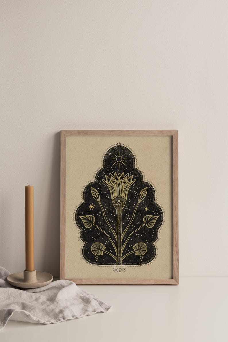 May include: A framed print with a black and gold design of a stylized flower with a sun and stars. The print has the word "remarkable" at the bottom.