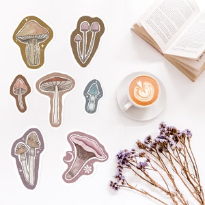 May include: A set of nine mushroom stickers with various colours and designs. The stickers are on a white background.