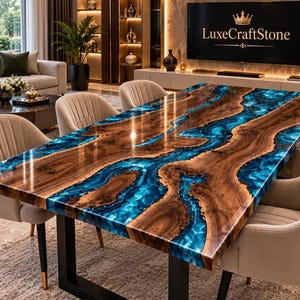 May include: A rectangular dining table featuring a natural wood slab with a glossy finish and a central river-like inlay of vibrant blue resin. The table is supported by black metal legs and is surrounded by six beige upholstered chairs.
