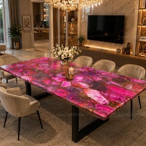 May include: A rectangular dining table featuring a vibrant, polished pink and purple agate stone slab top with natural crystalline patterns, supported by a sturdy black metal frame, accompanied by six beige upholstered chairs with black legs.
