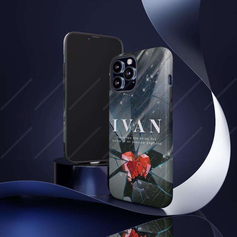 May include: A smartphone case with a dark, abstract design featuring the name "IVAN" in white text. The case has a broken glass effect with a red heart graphic. A second phone is visible in the background.
