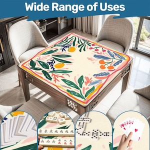 May include: A wooden table with a floral patterned tablecloth. The tablecloth features a cream background with green leaves, orange fruit, and pink and yellow accents. The image includes the text "Wide Range of Uses".