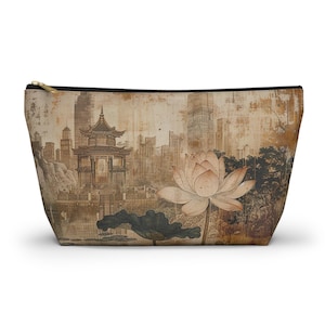 May include: A beige zippered pouch featuring a vintage-style illustration of a pagoda, lotus flower, and cityscape. The design incorporates sepia tones and a gold zipper, creating a unique aesthetic.