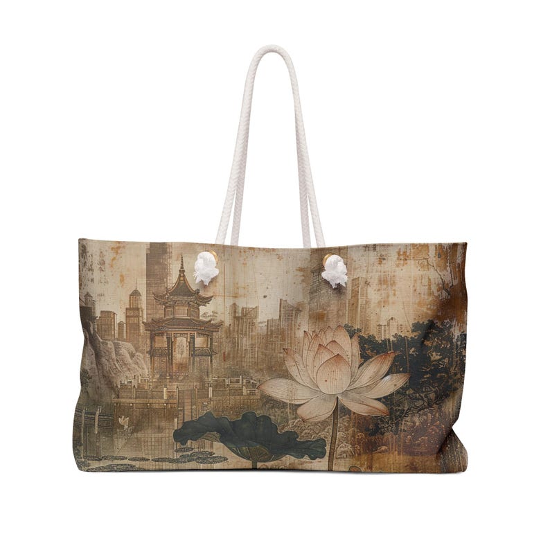 May include: Large tote bag featuring a vintage-style Asian landscape with a pagoda, city skyline, and a lotus flower. The bag has white rope handles and a neutral color palette.