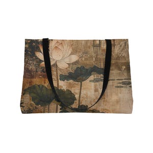 May include: Tote bag featuring a vintage-style illustration of a lotus flower and lily pads. The design includes a muted color palette with black straps. The bag is rectangular and appears to be made of fabric.