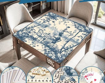 May include: A wooden table with a blue and white toile design, featuring a scene of people in a garden. The table is surrounded by chairs. The image also shows the table being used for playing cards, mahjong, and dominoes. Text at the top says "Wide Range of Uses."