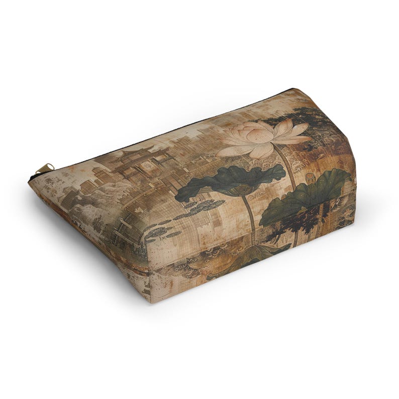May include: Rectangular beige cosmetic bag with a zipper closure. The bag features a vintage-style print of a lotus flower, leaves, and a traditional Asian building. The color palette includes shades of brown, beige, and green.