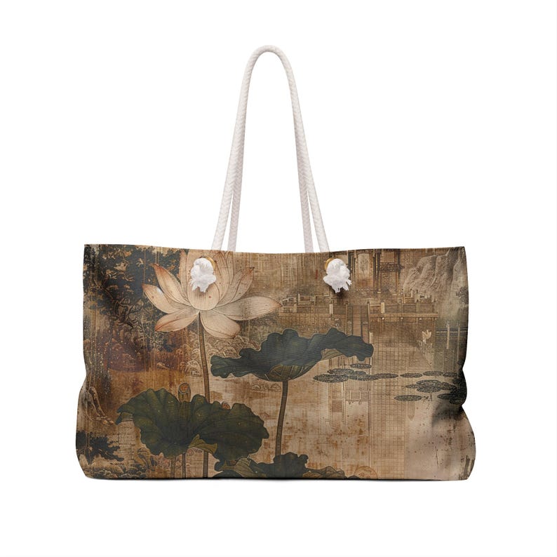May include: Large tote bag featuring a vintage-style illustration of a lotus flower and leaves. The bag has a cream-colored rope handle and a rectangular shape. The artwork is in muted tones of brown, beige, and green.