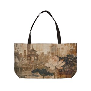 May include: Tote bag featuring an Asian-inspired design. The bag displays a sepia-toned illustration of a pagoda, lotus flower, and cityscape. The bag has black handles and a rectangular shape.