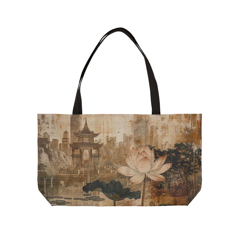 May include: Tote bag featuring an Asian-inspired design. The bag displays a sepia-toned illustration of a pagoda, lotus flower, and cityscape. The bag has black handles and a rectangular shape.