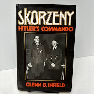 May include: A hardcover book titled "SKORZENY Hitler's Commando" by Glenn B. Infield. The cover features a black and white photograph of two men in uniform. The title and author's name are in white and orange text.