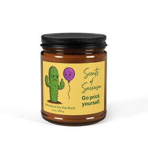 May include: A brown glass jar with a black lid. The label features a green cactus giving the middle finger, a purple balloon, and the text "Scents of Sarcasm. Go prick yourself." The candle contains 255 g of natural soy wax.