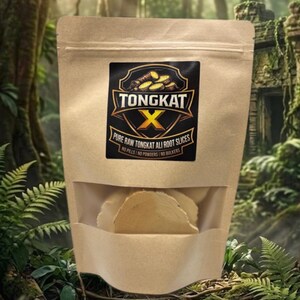 May include: A brown paper bag with a clear window, containing light-coloured slices. The bag features a black and gold label with the text "TONGKAT X" and "PURE RAW TONGKAT ALI ROOT SLICES". The background is a verdant forest.
