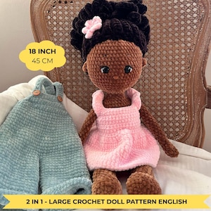 May include: A handmade crochet doll with brown skin, wearing a pink dress and a flower in her hair. The doll is 18 inches (45 cm) tall. Next to the doll is a pair of blue overalls. The text on the image says "2 IN 1 - LARGE CROCHET DOLL PATTERN ENGLISH".