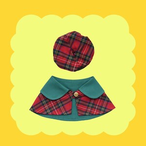 May include: A red and black plaid dog collar with a green collar and a matching red and black plaid hat.