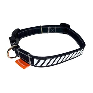 May include: Black dog collar with a white reflective stripe pattern and a small orange tag that says "Muddy Paws".